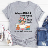 Being An Adult Is Like Folding A Fitted Sheet No One Really Knows How  T-Shirt