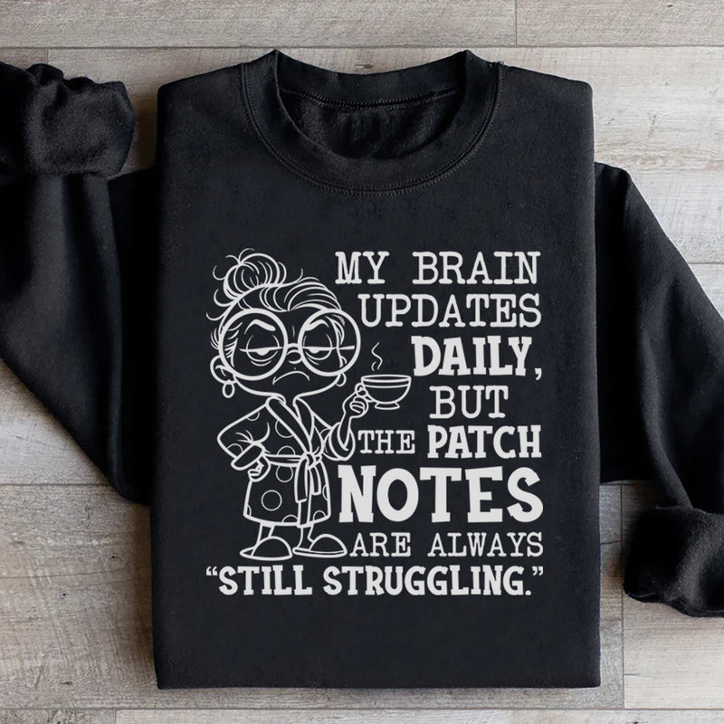 My Brain Updates Daily, But the Patch Notes Are Always ‘Still Struggling Sweatshirt