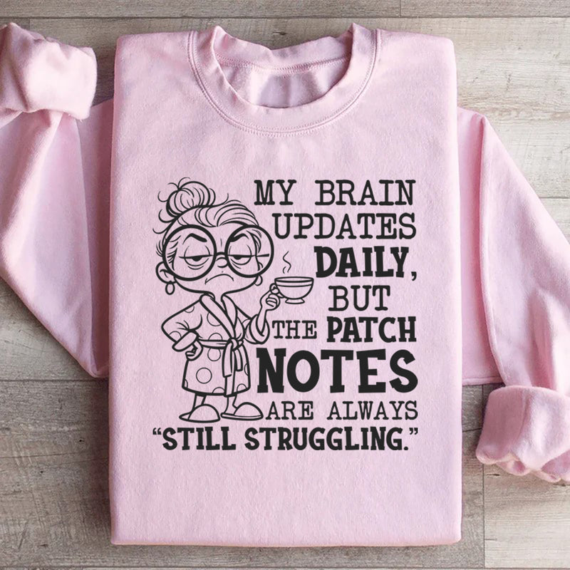 My Brain Updates Daily, But the Patch Notes Are Always ‘Still Struggling Sweatshirt