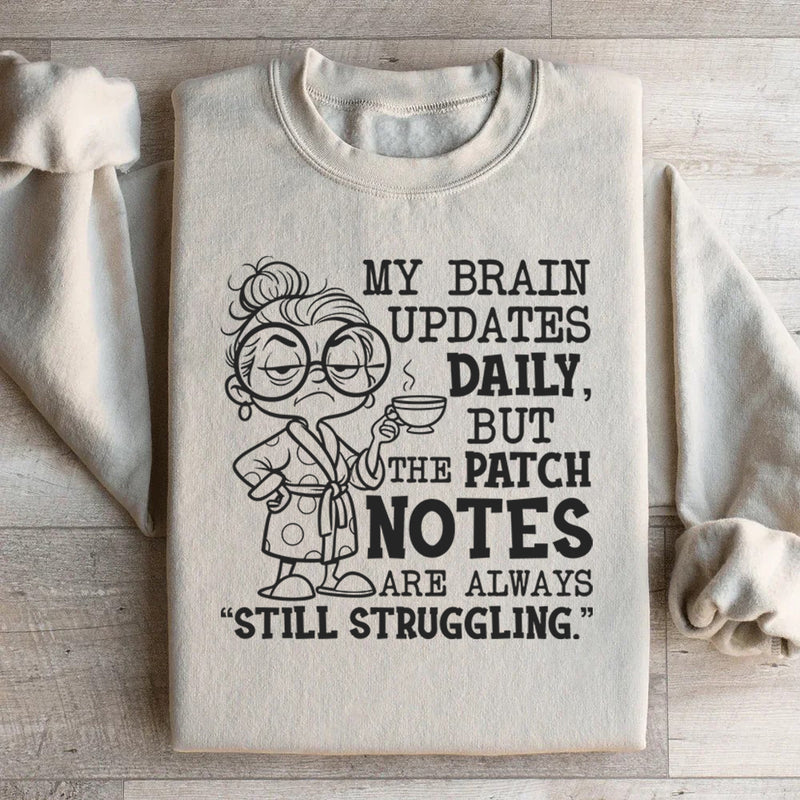 My Brain Updates Daily, But the Patch Notes Are Always ‘Still Struggling Sweatshirt
